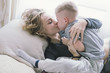 © Andrei Aleshyn/Stocksy - beautiful young mother kissing her son