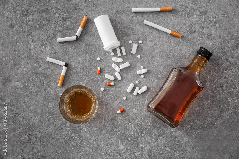 drugs cigarettes and alcohol Composition with alcohol, cigarettes and drugs on table. Concept of bad  habits Stock Photo