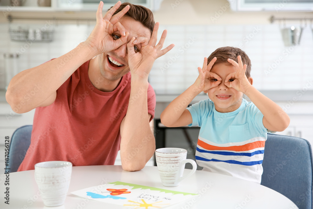 Father and son having fun in kitchen