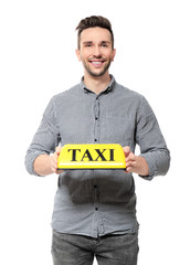 Poster - Young driver with taxi roof light on white background