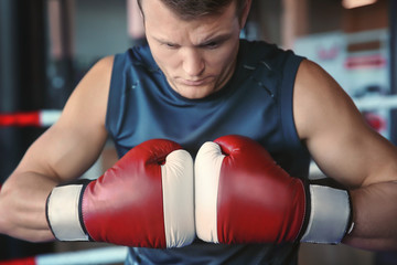 Wall Mural - Young man training in boxing ring