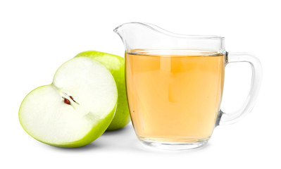 Glass jug with apple vinegar and fresh fruit on white background