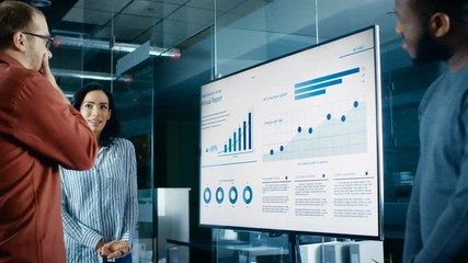 Poster - Diverse Team of Business Workers in Conference Room Have Discussion about Statistics and Graphs Shown on a Presentation TV.  Shot on RED EPIC-W 8K Helium Cinema Camera.