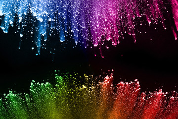 abstract colored dust explosion on a black background.abstract powder splatted background,Freeze motion of color powder exploding/throwing color powder, multicolored glitter texture.