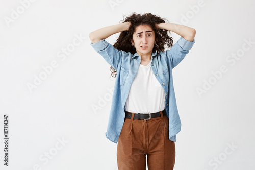 Stressed Puzzled Young Casually Dressed Girl With Hands In Dark