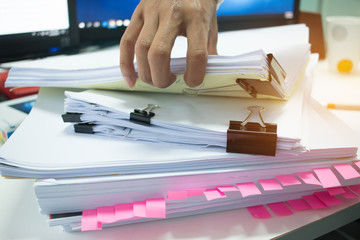 Canvas Print - Businessman hands working on Stacks of documents files for finance in office. Business report papers or Piles of unfinished document achieves with black clip paper. Concept of Business Annual Report