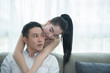 © reewungjunerr - Asian couple in the livingroom,woman hug man from back,Picture of valentine day concept