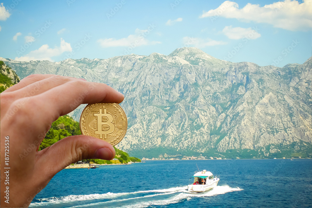 Hand holding golden bitcoin virtual money Shell with a golden bitcoin coin on the background of sea waves and the ocean find bitcoin