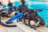 Equipment for diving is on the edge of the pool, ready for a lesson