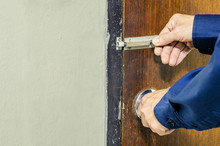 Man Is Hand Holding Metal Door Bolt Lock Or Latch For Open Or Close The Door.