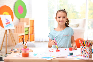 Poster - Little girl painting at table indoors