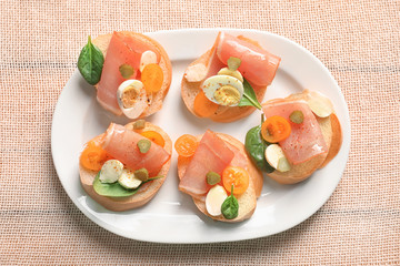 Wall Mural - Plate with tasty fresh bruschettas on table