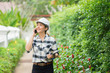 © Have a nice day  - environment engineer, confident Young Asain woman engineer wearing white hardhat helmet and  talking on mobile phone while working by green field  smartphone and digital tablets for social networks,