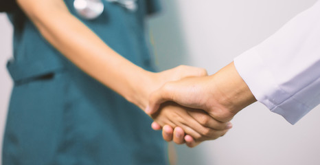 Surgeon medical people handshaking.Doctors and nurses in a medical team stacking handsCross processing and blue tone color