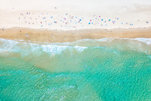 People Swimming At The Beach In Summer With Blue Water From An Aerial Perspective
