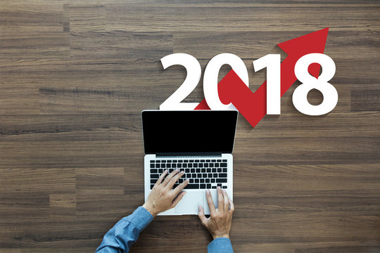Business graph with arrow up and 2018 symbol, Success concept and growth idea concept, With businessman working on laptop computer PC, Top view from above