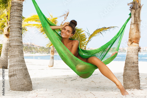 Happy and beautiful woman lying in the hammock Tableau sur Toile