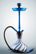 Blue hookah with black rubber tube and blue and white flask on light grey background.