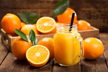 Wall Mural - glass jar of fresh orange juice with fresh fruits