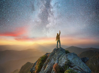 Wall Mural - silhouette of a champion on mountain peak. active life concept