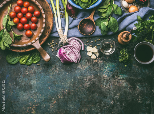 Fotomural Vegetarian cooking ingredients with fresh seasoning on rustic kitchen table with spoon , top view, place for text