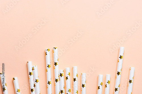 Elegant White Paper Drinking Straws with Golden Stars Pattern Scattered as Border Frame on Pink Peachy Background Poster