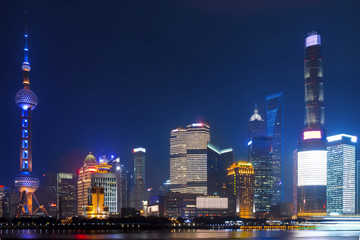 Modern city skyscrapers of Shanghai skyline at night with reflection of beautiful ligth in Huangpu river view from the bund, Shanghai, China