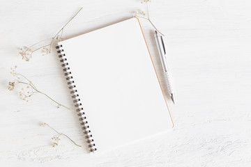 Wall Mural - flat lay photo of office desk on white background,empty notebook open on white wood table