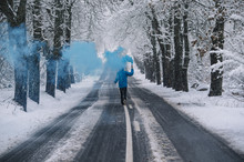 Person With Blue Bengal On The Winter Snowy Road