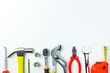 © Goodvibes Photo - Top view of Working tools,wrench,socket wrench,hammer,screwdriver,plier,electric drill,tape measure,machinist square and safety glasses on white background.flat lay design for construction concept