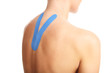 © Kalim - Picture showing special physio tape put on injured back over white background