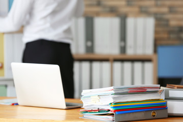 Canvas Print - Stack of documents on office employee's table, closeup