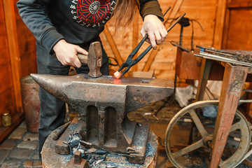 blacksmith working with hot metal at fair