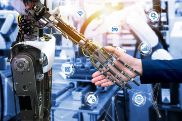 Wall Mural - Cyber communication and robotic trend and artificial intelligence concepts. Industrial 4.0 Cyber Physical Systems concept. Robot and Engineerer human holding hand with handshake and graphic.