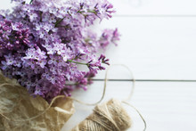 Lilac Flowers On White Old Wooden Background