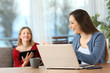 © Antonioguillem - Roommates talking about content on multiple wifi devices