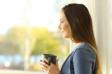 Profile of a woman looking through a window