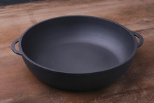 A New, Clean And Empty Cast-iron Pan For The Grill.