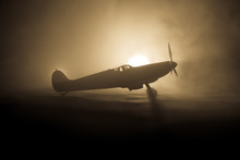 British Jet-propelled Model Plane In Possession. Dark Orange Fire Background. War Scene.