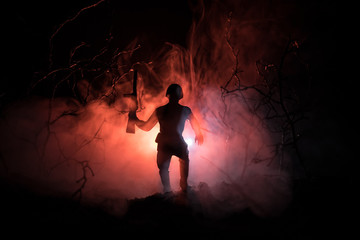 Black silhouettes of soldier in the smoke fire burning moving in battle operation. Back light. Toned