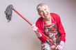 © Teodor Lazarev - Cleaning senior lady crazy and frustrated, threatening to beat you with a mop