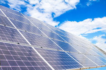  Solar  power panels for innovation green energy for life with mountains and blue sky background.