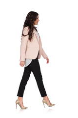 Wall Mural - young woman in business clothes is walking and smiles