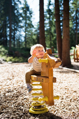 Wall Mural - Cute little boy on the playground.