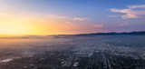 Fototapeta Morze - Beautiful sunset over the center of Los Angeles viewed from an rising airplane