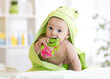 © Oksana Kuzmina - Baby with green towel after the bath biting toy