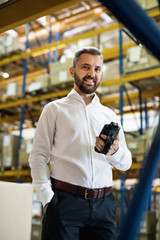 Poster - Warehouse worker or supervisor with barcode scanner.