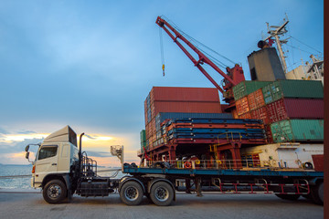 lorry trailer and truck delivery unit container to the ship in the port terminal, wharf where sea and land transport meet together being for transport and logistics services in global worldwide