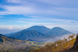 Fototapeta Tęcza - Landscape view of big mountains at Kawah Ijen volcano. Ijen volcano the famous tourist attraction near Banyuwangi, East Java, Indonesia