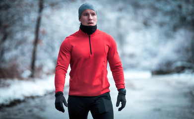 Athlete wearing warm sporty running clothes, winter exercise outdoor